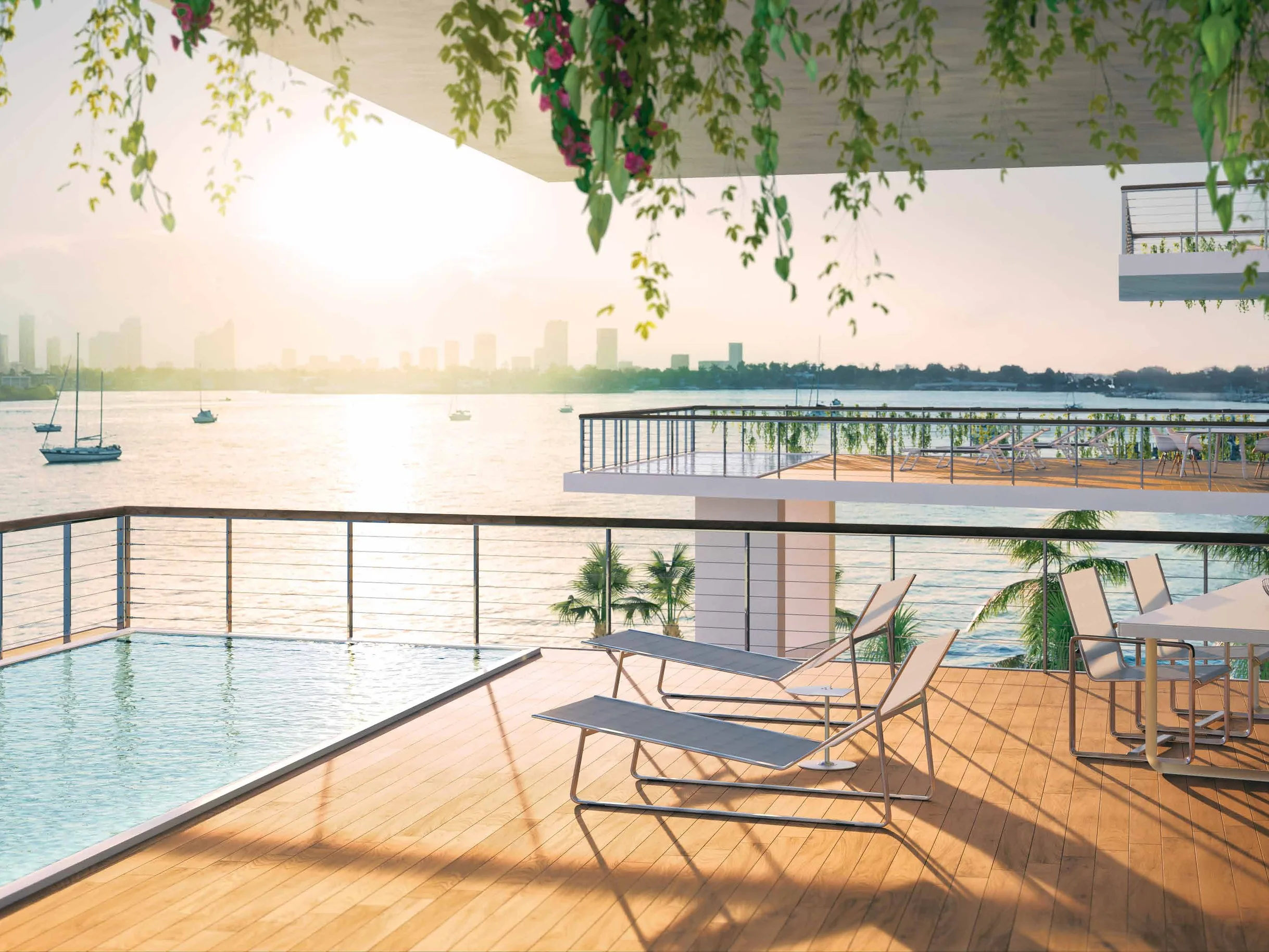 An upper-floor terrace with a private pool at the edge, looking west over Biscayne Bay at sunset